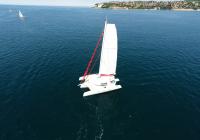 white trimaran yacht sailing at blue sea